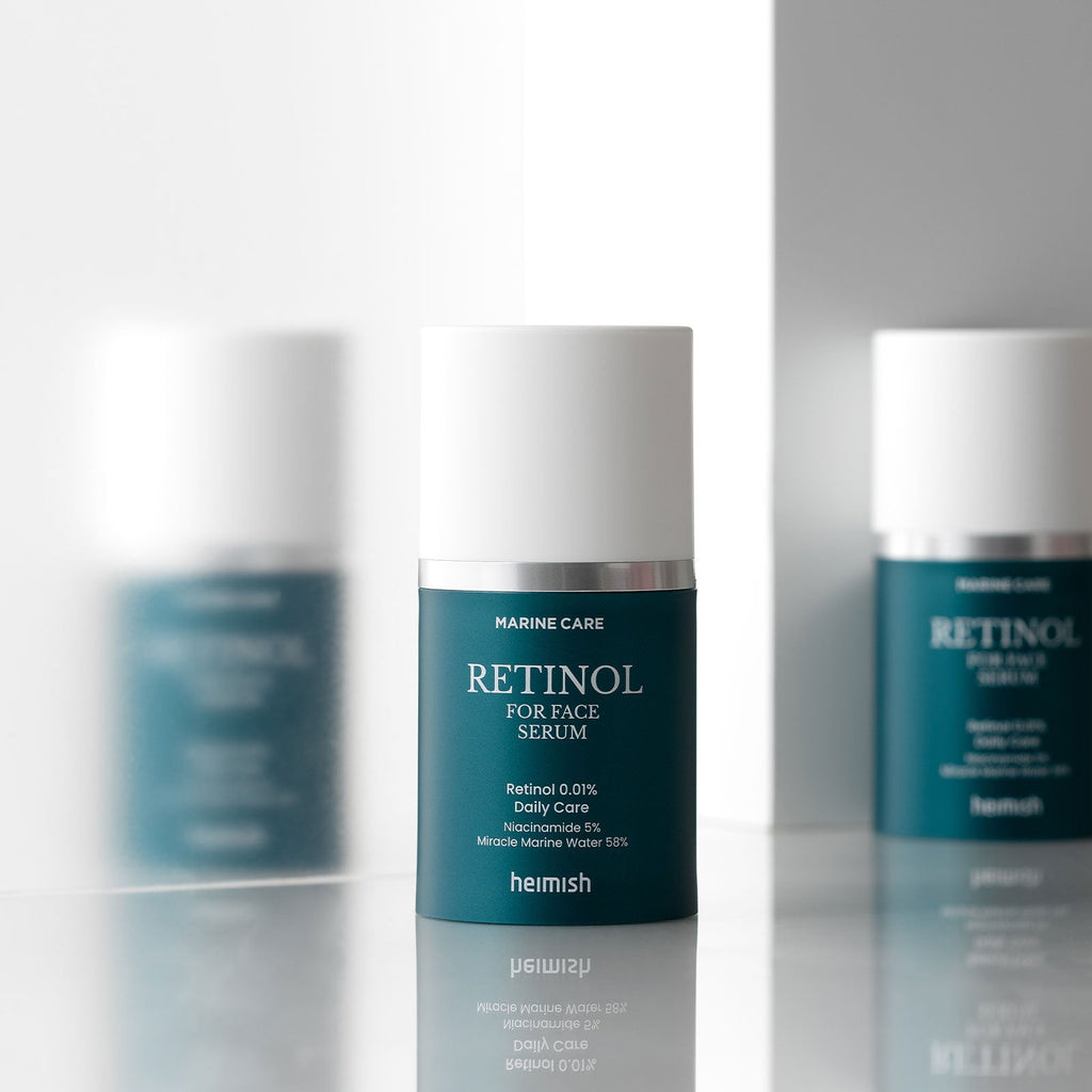 Heimish Marine Care Retinol For Face Serum 50 ml bottle reflected between two matching bottles.