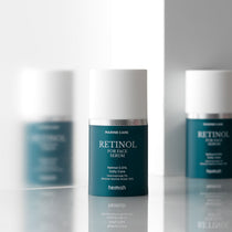 Heimish Marine Care Retinol For Face Serum 50 ml bottle reflected between two matching bottles.