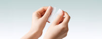 Abib Green LHA Pore Pad Clear Touch: hands separating a pad along its split line