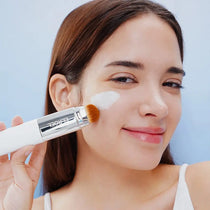 Model applying Blanc Cover Cream Stick V with its brush