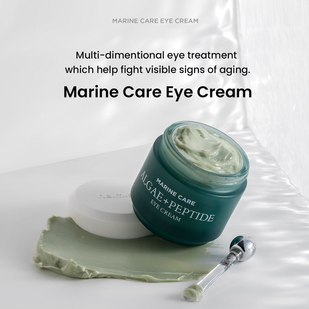 Heimish Marine Care Eye Cream - 30ml — open 30 ml eye-cream jar and metal applicator on a sweep of green cream.