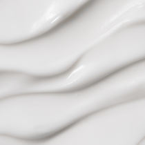 Heimish Moringa Ceramide Hyaluronic Hydrating Cream - 50ml — macro photograph of the cream’s smooth ridged texture.
