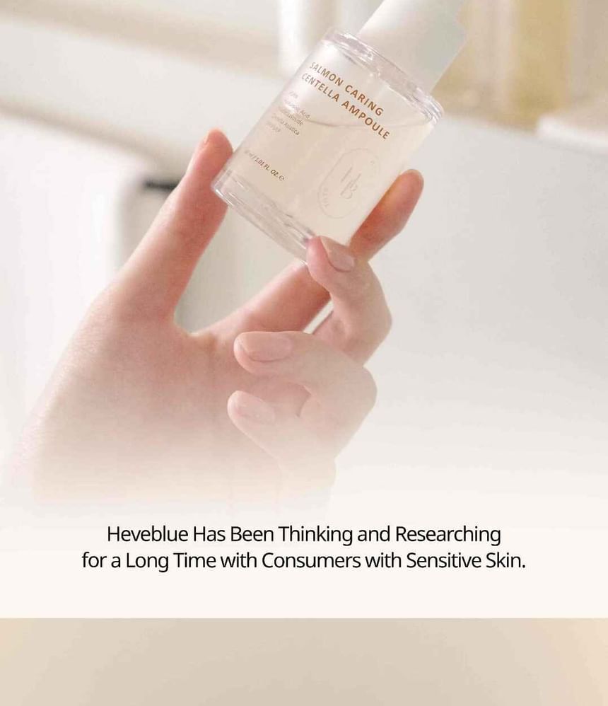 Heveblue Salmon Caring Centella Ampoule 30 ml — dropper dispensing ampoule onto the hand.