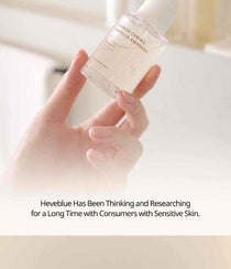 Heveblue Salmon Caring Centella Ampoule 30 ml — dropper dispensing ampoule onto the hand.