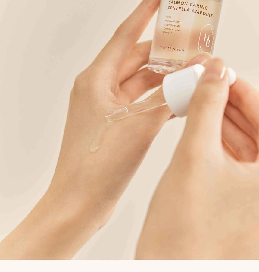 Heveblue Salmon Caring Centella Ampoule 30 ml — ampoule applied with a cotton pad.