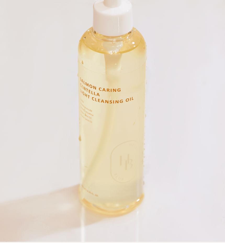 Heveblue Salmon Caring Centella Light Cleansing Oil - 250ml — oil bottle with cap removed.