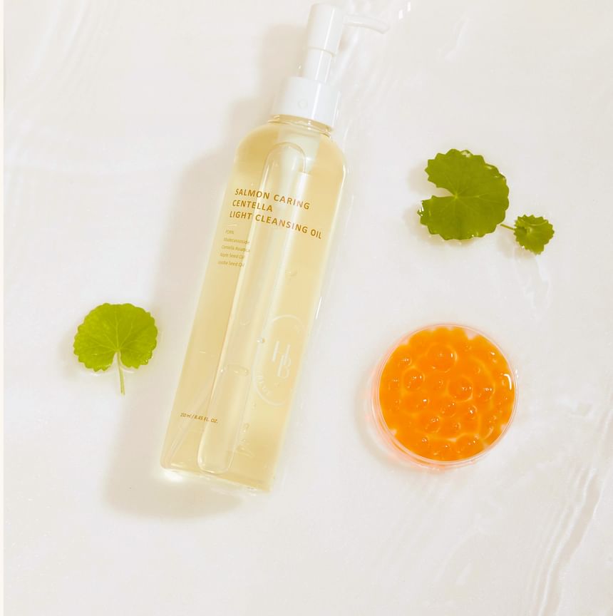 Heveblue Salmon Caring Centella Light Cleansing Oil - 250ml — bottle with centella and salmon-egg props.