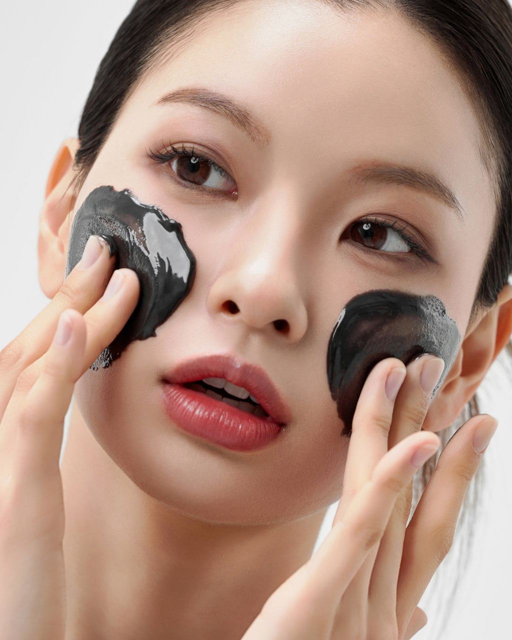 Model massaging House of HUR Midnight Soothing Cleansing Balm over her cheeks