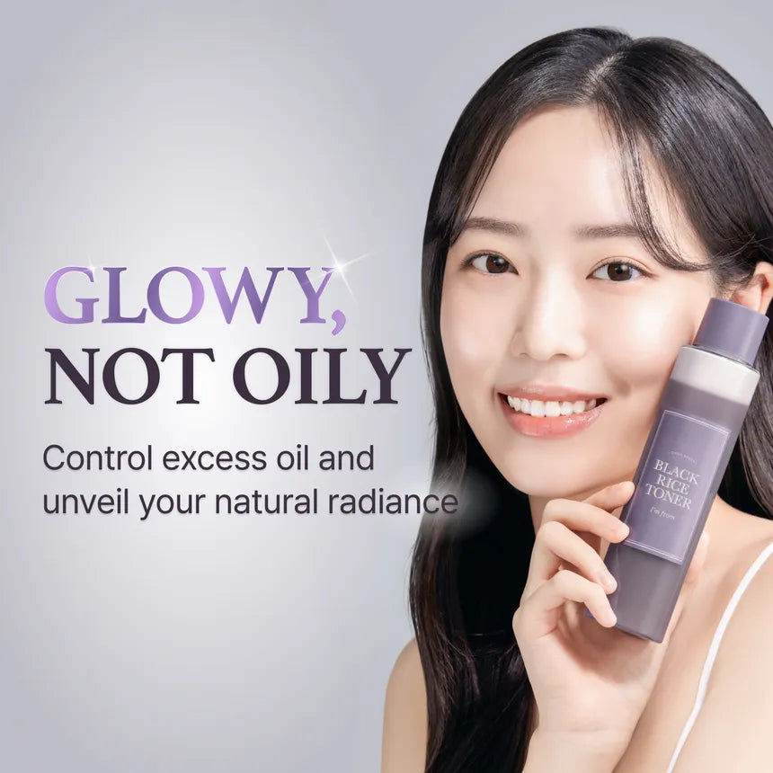 I'm From Black Rice Toner — model holding the black-rice toner bottle beside her face