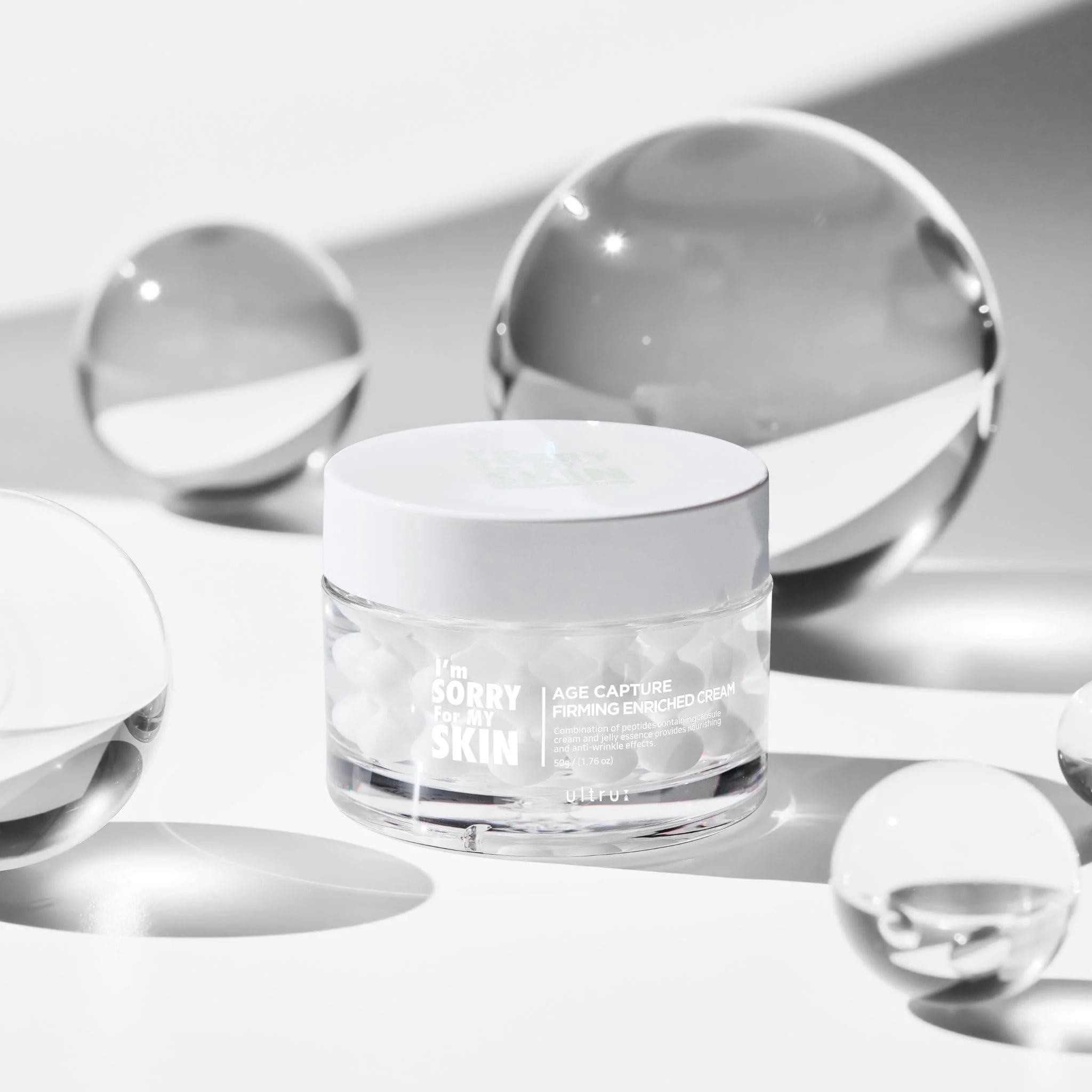 <h2>I’m Sorry For My Skin AGE Capture Firming Enriched Cream 50g</h2> <h3>Overview</h3> <p>The <strong>I’m Sorry For My Skin AGE Capture Firming Enriched Cream</strong> is an anti-aging cream designed to firm, nourish, and revitalize mature skin. It helps improve elasticity, reduce the appearance of fine lines and wrinkles, and provide deep hydration for a smoother, youthful complexion.</p> <h3>Benefits</h3> <ul> <li><strong>Firming:</strong> Enhances skin elasticity and tightens sagging areas.</li> <li><strong>Nourishing:</strong> Provides deep hydration and essential nutrients to the skin.</li> <li><strong>Anti-Aging:</strong> Helps reduce fine lines and wrinkles for a youthful look.</li> <li><strong>Soothing:</strong> Gentle formula suitable for sensitive skin while improving texture.</li> </ul> <h3>How to Use</h3> <ol> <li>After cleansing and toning, take an appropriate amount of the cream.</li> <li>Apply evenly to the face and neck.</li> <li>Gently massage in upward circular motions until fully absorbed.</li> <li>Use daily, preferably in the evening for optimal results.</li> </ol> <h3>Key Ingredients</h3> <ul> <li><strong>Peptides:</strong> Promote collagen production and improve firmness.</li> <li><strong>Niacinamide:</strong> Enhances skin barrier and brightens skin tone.</li> <li><strong>Hyaluronic Acid:</strong> Provides deep hydration and plumps the skin.</li> <li><strong>Botanical Extracts:</strong> Nourish, soothe, and protect skin from oxidative stress.</li> </ul> <h3>Short Description (EN)</h3> <p>Firming anti-aging cream that nourishes and hydrates mature skin.</p> <p>Reduces fine lines, improves elasticity, and revitalizes skin for a youthful glow.</p> <h3>Meta (EN)</h3> <p><strong>Meta Title:</strong> I’m Sorry For My Skin AGE Capture Firming Enriched Cream | Anti-Aging & Firming | %sitename%</p> <p><strong>Meta Description:</strong> Nourish and firm your skin with I’m Sorry For My Skin AGE Capture Cream. Reduces fine lines and improves elasticity. Shop now!</p> <h3>Tags (EN)</h3> I’m Sorry For My Skin, AGE Capture Firming Enriched Cream, Cream, Anti-Aging, Firming, Hydrating, Peptides, Niacinamide, Hyaluronic Acid